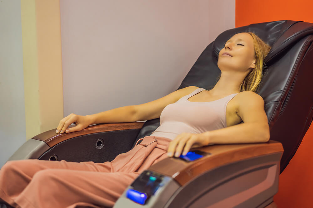 Young woman relaxing on the massage chair